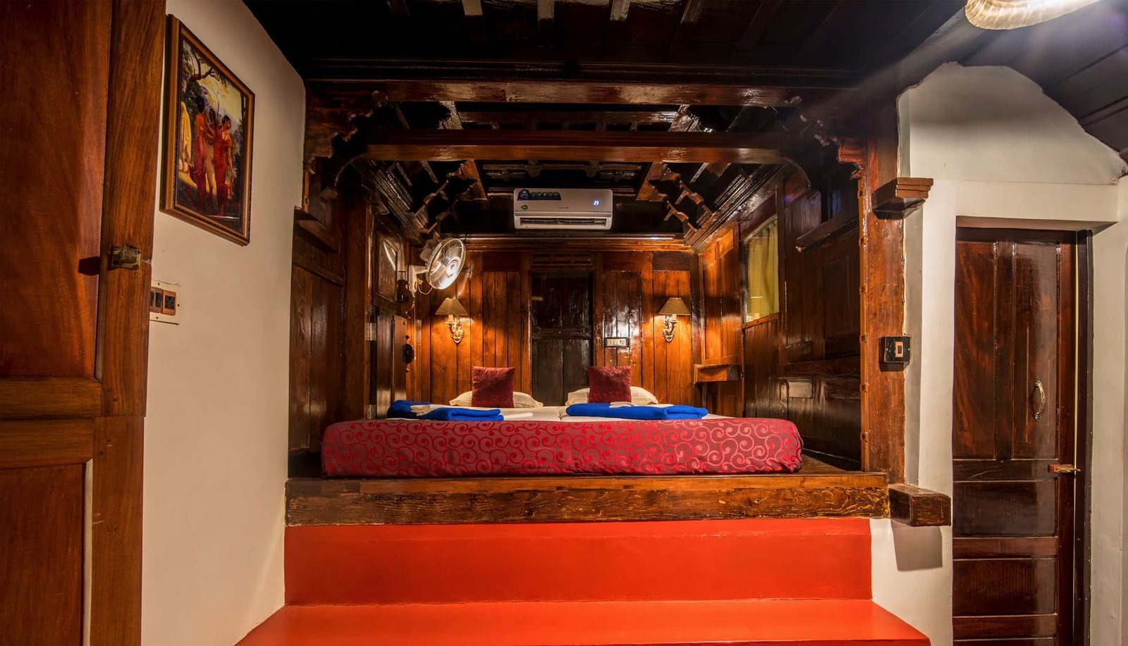 A panelled passage in dark teak opening into a bedroom